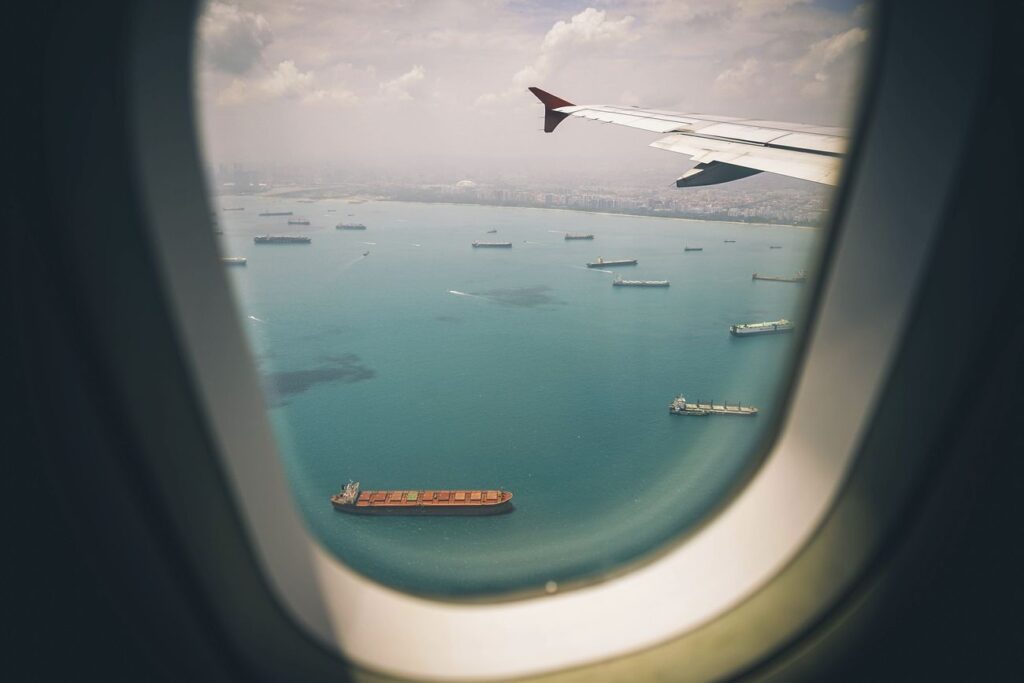 Airplane window with sea view
